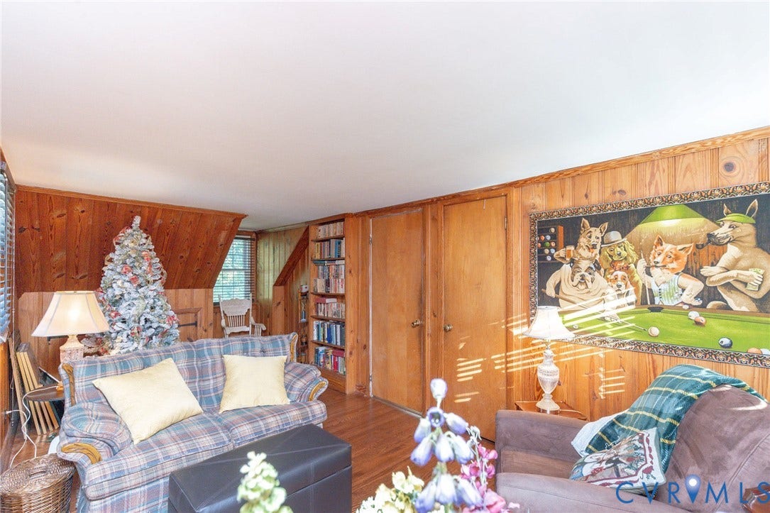 5211 W Grace Street, Richmond, VA 23226 Interior space featuring wood-paneled walls, built-in shelving, and wood-finish flooring