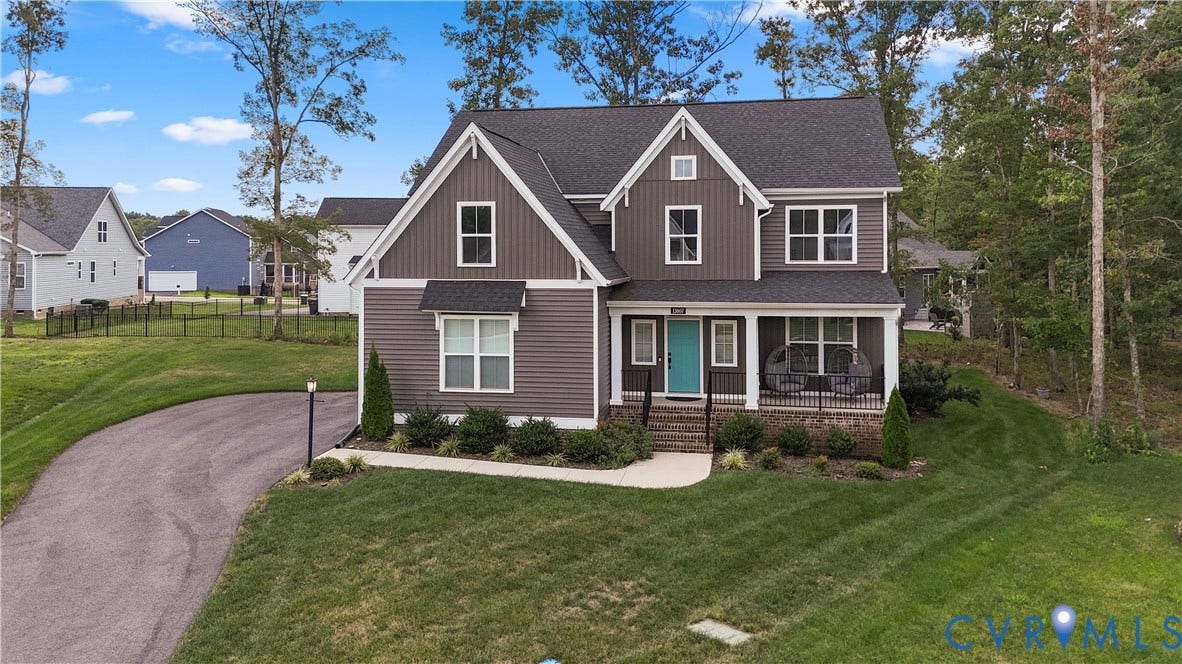 13807 Denleigh Court, Midlothian, VA 23112 Two-story residence featuring vertical and horizontal siding, a covered front porch with iron railings, multi-gabled roofline, asphalt driveway, and manicured landscaping