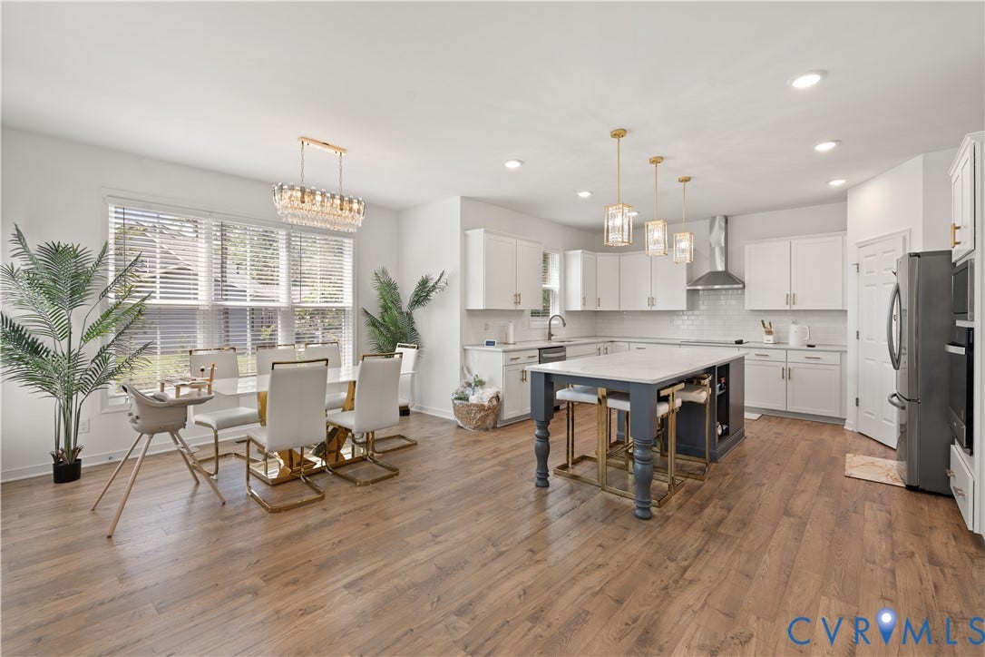 13807 Denleigh Court, Midlothian, VA 23112 Open-concept kitchen and dining area featuring wood-finish flooring, a central island with a stone countertop, white cabinetry, integrated stainless steel appliances, and tiered pendant lighting