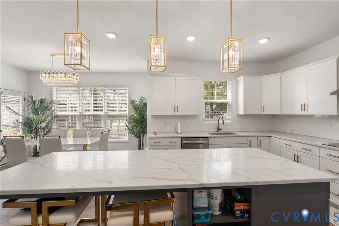 13807 Denleigh Court, Midlothian, VA 23112 Kitchen featuring an expansive island with a solid surface countertop, white shaker-style cabinetry, subway tile backsplash, and decorative geometric pendant lighting