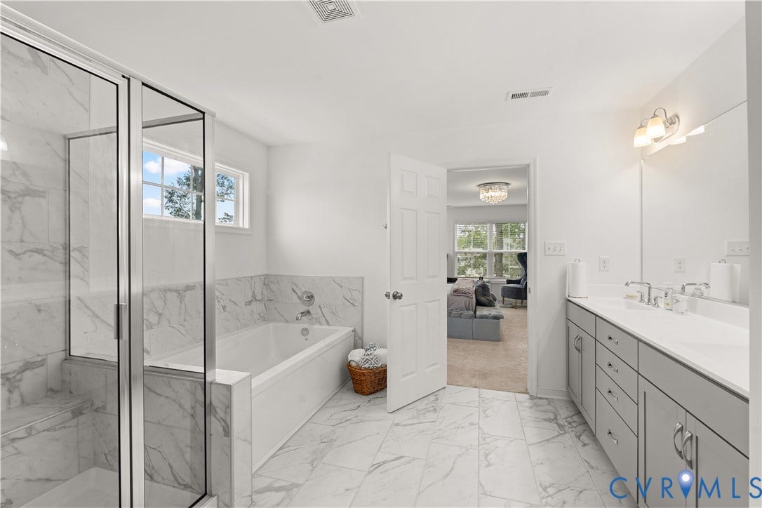 13807 Denleigh Court, Midlothian, VA 23112 Bathroom featuring a glass-enclosed shower, a deep soaking tub with stone-patterned tile surround, dual-sink vanity with grey cabinetry, and large-format tile flooring