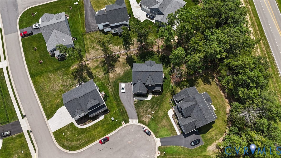 13807 Denleigh Court, Midlothian, VA 23112 Aerial perspective of a residential cul-de-sac featuring asphalt driveways, manicured green spaces, and substantial wooded perimeter boundaries