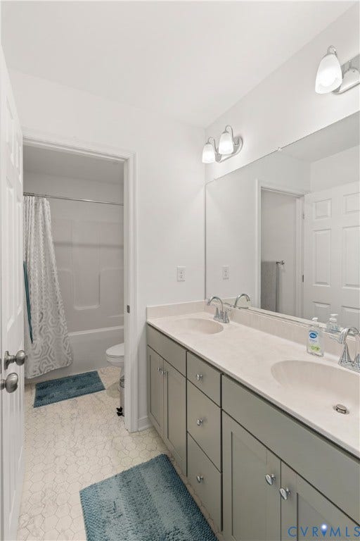 13807 Denleigh Court, Midlothian, VA 23112 Dual vanity with integrated sinks, neutral-toned cabinetry, polished chrome fixtures, full-width wall mirror, and tub-shower combination