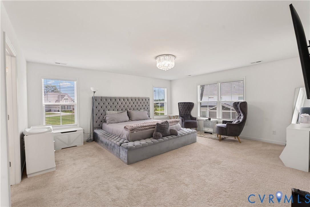 13807 Denleigh Court, Midlothian, VA 23112 Spacious room featuring neutral carpeting, multi-pane windows, and a central crystal-style flush mount light fixture