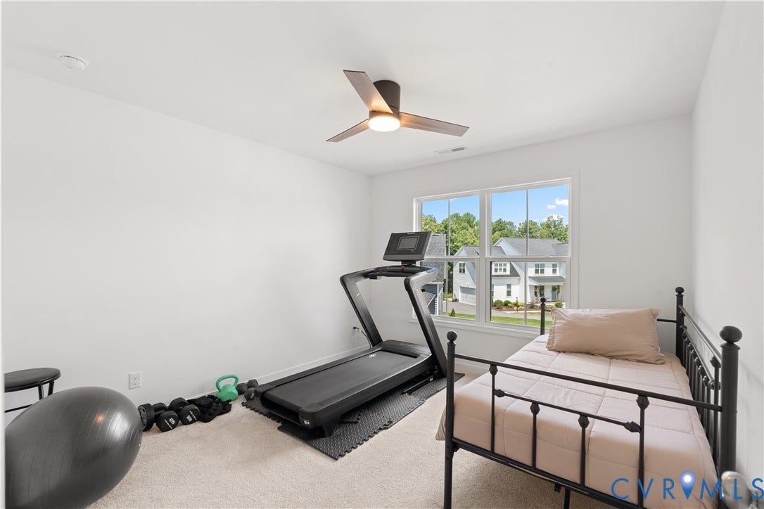 13807 Denleigh Court, Midlothian, VA 23112 Neutral-toned room featuring wall-to-wall carpeting, a contemporary three-blade ceiling fan with integrated lighting, and a double-hung window