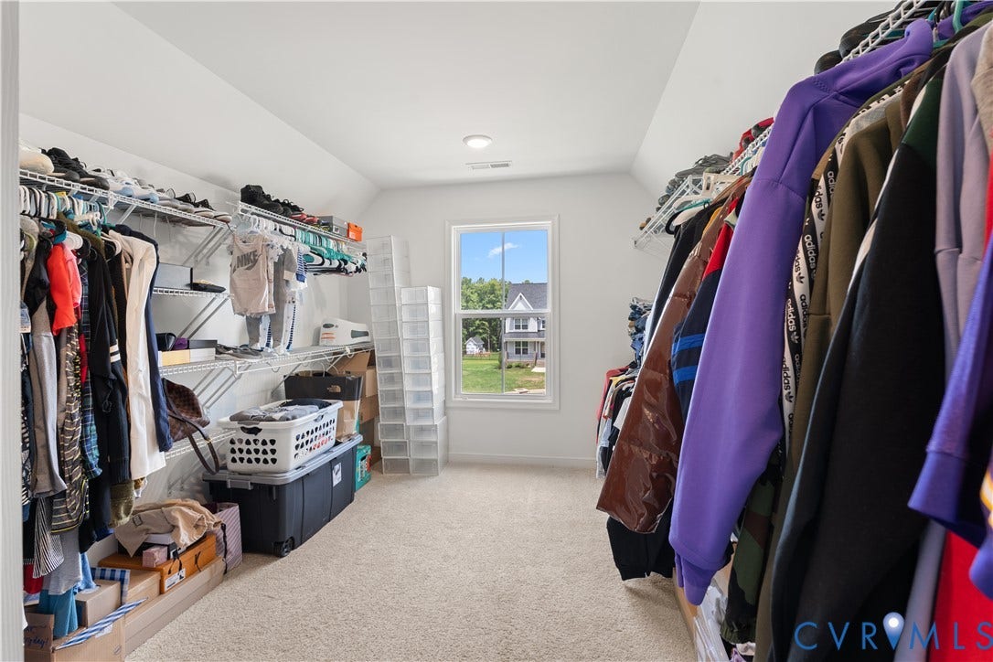13807 Denleigh Court, Midlothian, VA 23112 Walk-in closet featuring neutral carpeting, white walls, vaulted ceilings, a single-hung window, and multi-tiered wire shelving