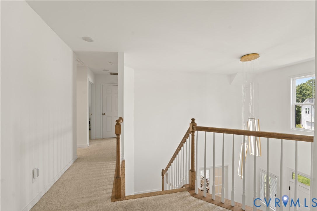 13807 Denleigh Court, Midlothian, VA 23112 Stairwell landing featuring a wood handrail, white balusters, carpeting, and a multi-pendant light fixture