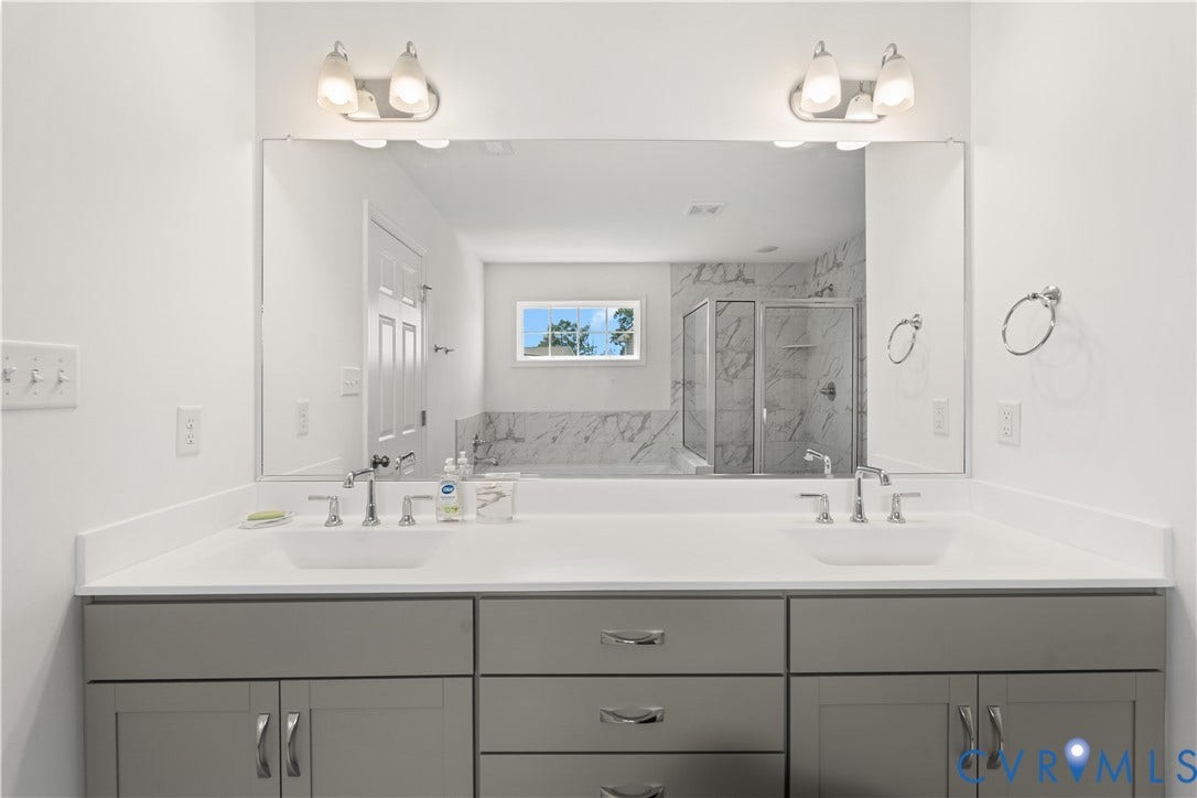 13807 Denleigh Court, Midlothian, VA 23112 Dual-sink vanity with white countertops, grey shaker-style cabinetry, a wall-to-wall mirror, and dual light fixtures