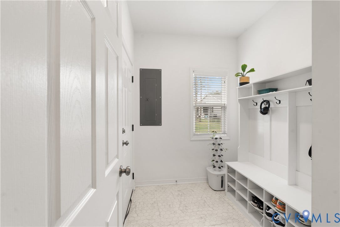 13807 Denleigh Court, Midlothian, VA 23112 Built-in white storage cabinetry featuring open shelving and wall-mounted hooks, white-toned flooring, and a window with horizontal blinds