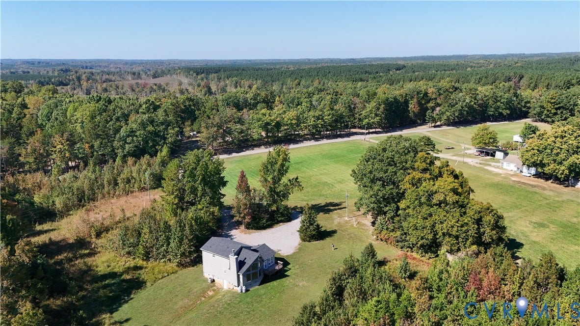6502 Nutbush Road, Rural Countryside, Lunenburg, VA 23942 Aerial perspective of a multi-story residence situated on a large lot featuring extensive acreage, mature perimeter trees, and an open grass field
