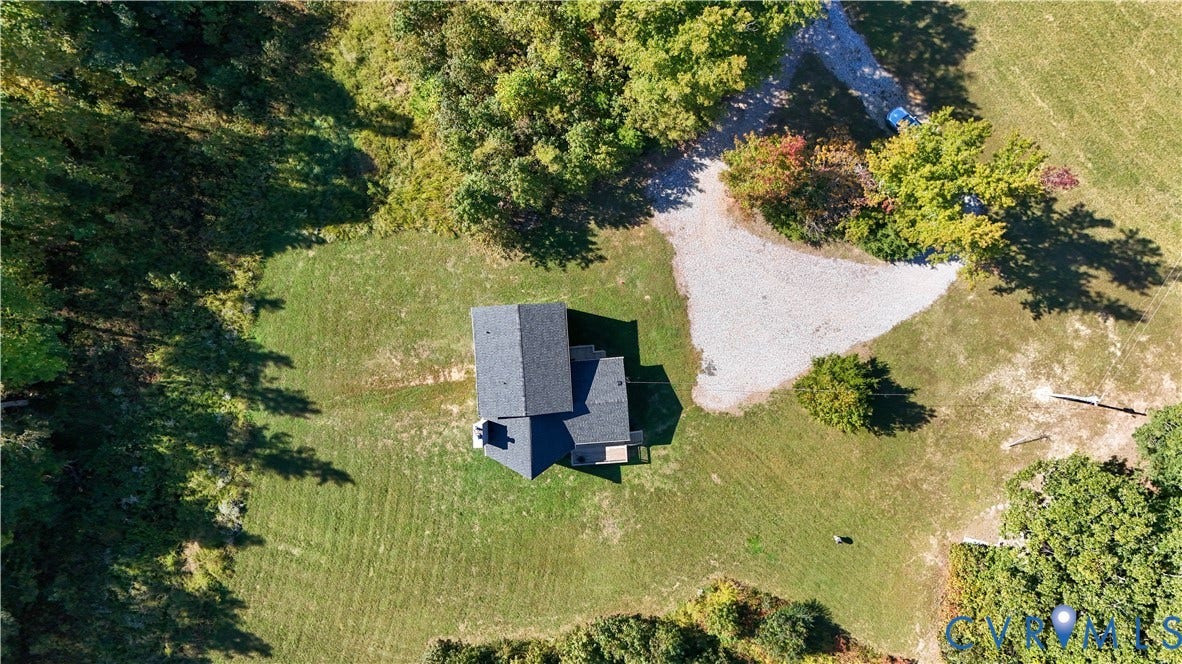 6502 Nutbush Road, Rural Countryside, Lunenburg, VA 23942 Aerial perspective featuring a shingled roof structure, a sprawling grass yard, mature perimeter trees, and a gravel driveway