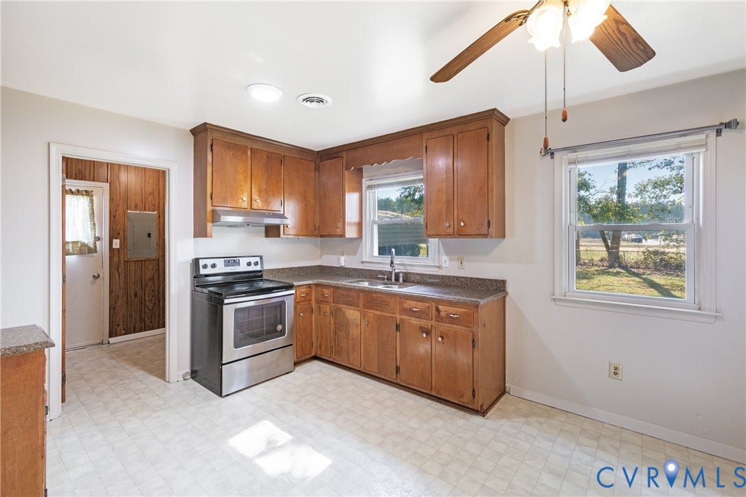 542 Petty Street, Petersburg, VA 23805 Kitchen featuring wood cabinetry, stone-finish countertops, stainless steel range with overhead hood, and a ceiling-mounted fan