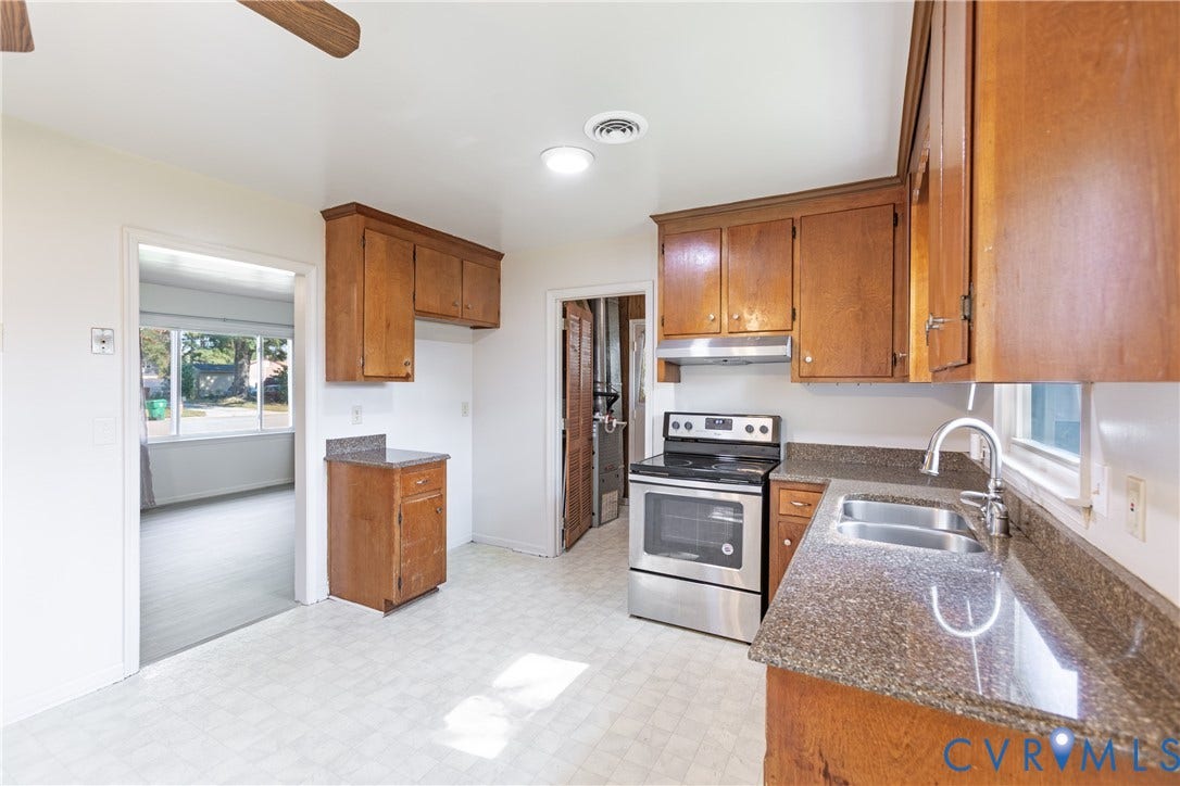 542 Petty Street, Petersburg, VA 23805 Kitchen featuring wood cabinetry, stone-finish countertops, a stainless steel range, and a dual-basin sink with a goose-neck faucet