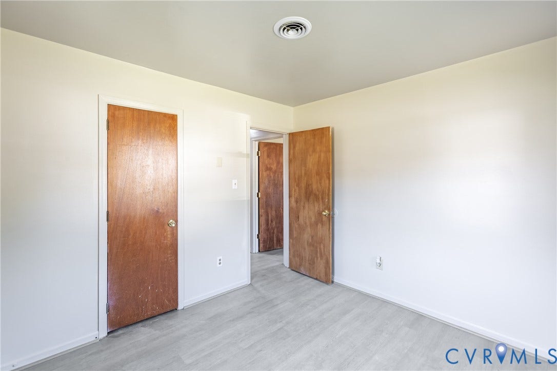 542 Petty Street, Petersburg, VA 23805 Neutral wall finishes, wood-finish interior doors with metallic hardware, and light-toned wood-finish flooring