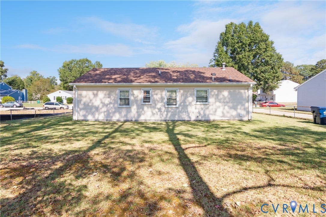 542 Petty Street, Petersburg, VA 23805 Exterior featuring light-toned horizontal siding, a gabled roof with composite shingles, and four windows