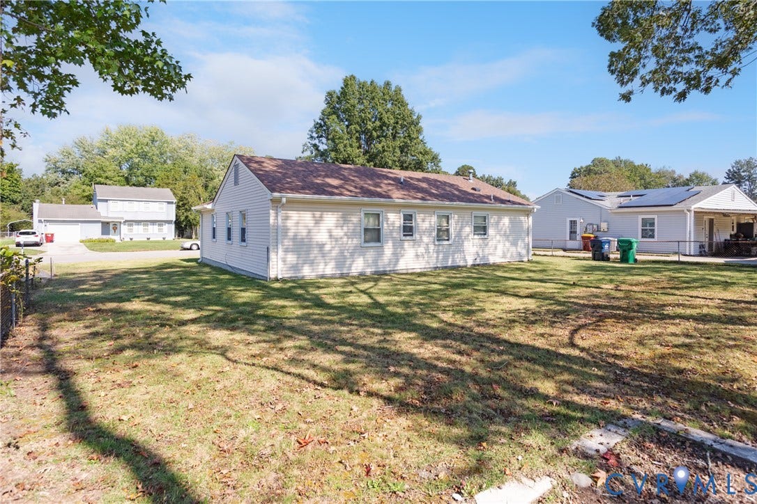 542 Petty Street, Petersburg, VA 23805 Exterior featuring light-colored horizontal siding, a gabled roofline, and an expansive lawn