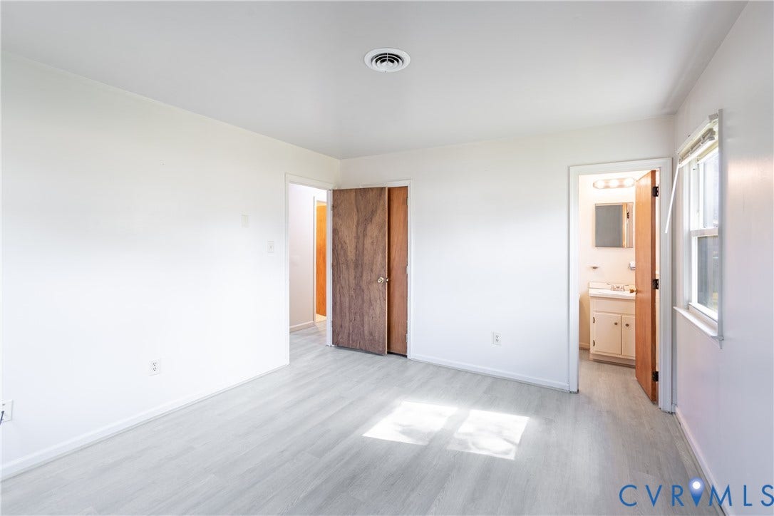 542 Petty Street, Petersburg, VA 23805 Neutral-toned wood-finish flooring, white walls, and interior wood-grain doors