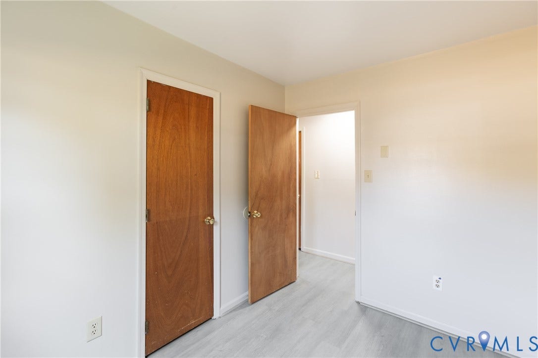 542 Petty Street, Petersburg, VA 23805 Interior space featuring neutral-toned walls, wood-finish flooring, and solid wood interior doors with metallic hardware