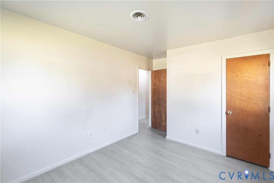542 Petty Street, Petersburg, VA 23805 Neutral interior space featuring wood-finish flooring, solid wood-core doors, and smooth-finish walls