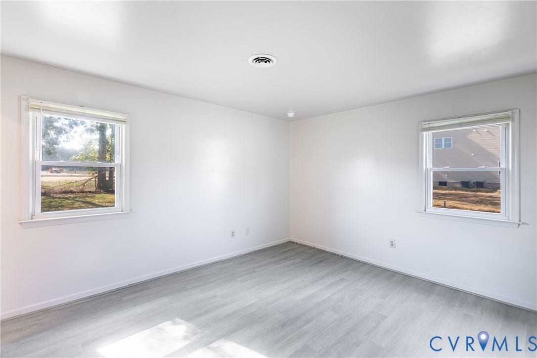 542 Petty Street, Petersburg, VA 23805 Neutral interior space featuring wood-finish flooring, crisp white wall finishes, and dual double-hung windows