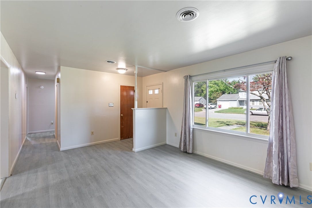 542 Petty Street, Petersburg, VA 23805 Interior featuring wood-finish flooring, a large picture window, and a built-in partial room divider