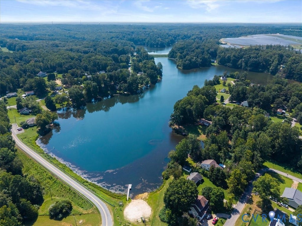 2242 Lakeview Drive, Powhatan, VA 23139 Aerial perspective featuring a large freshwater lake, extensive mature tree coverage, and a private dock