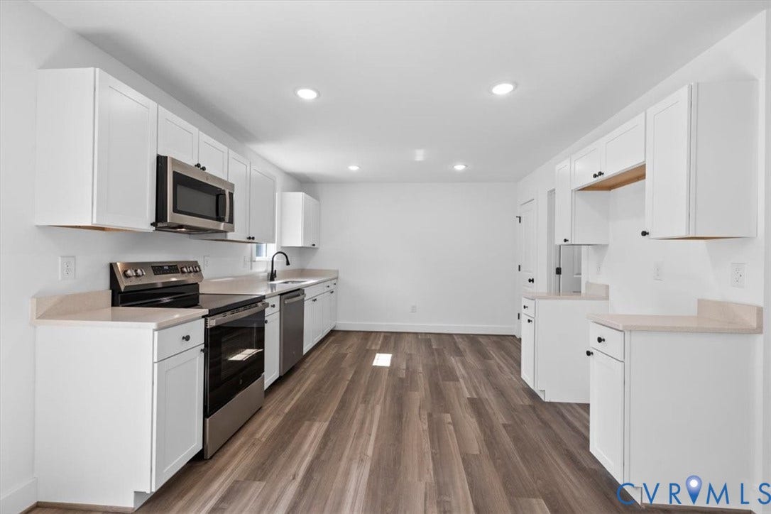 2242 Lakeview Drive, Powhatan, VA 23139 Kitchen featuring white cabinetry, solid-surface countertops, stainless steel appliances, and wood-finish flooring