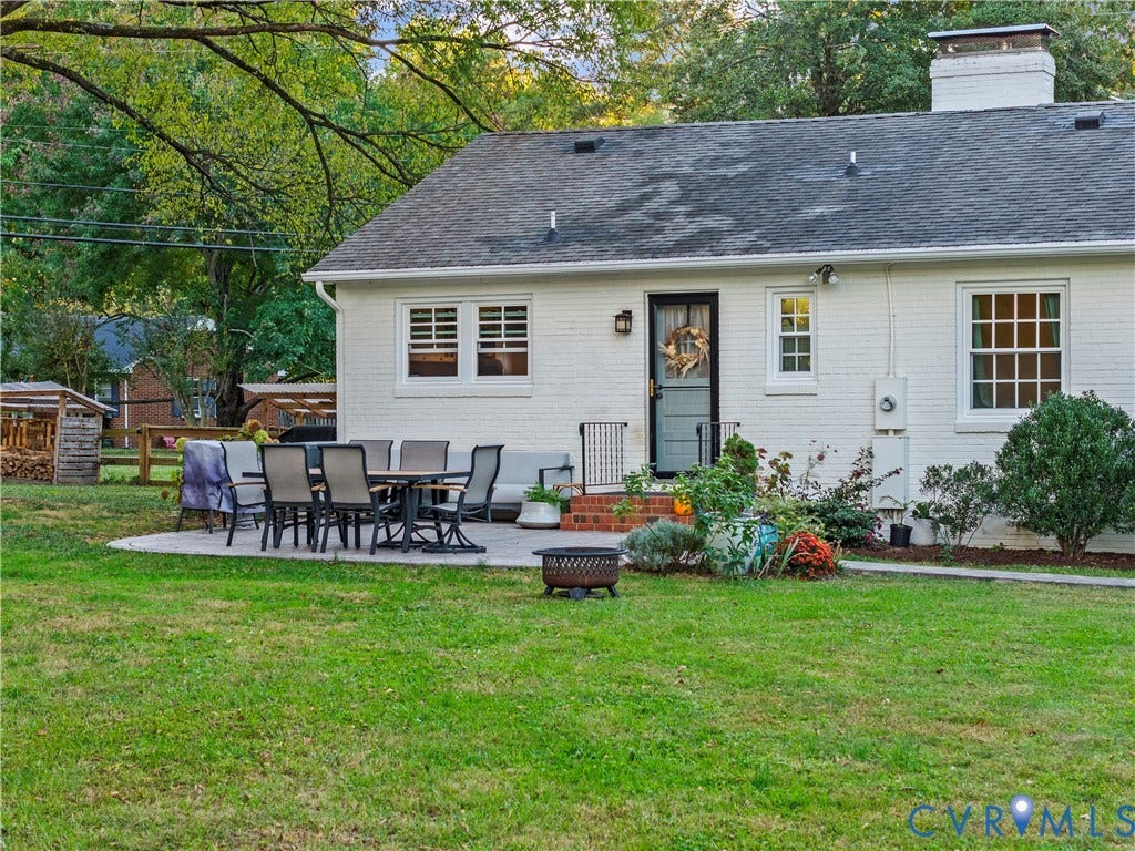 6956 Old Westham Road, Stratford Hills/Cherokee Road, Richmond, VA 23225 White painted brick exterior featuring a rear stone paver patio, a brick chimney, and multi-light windows