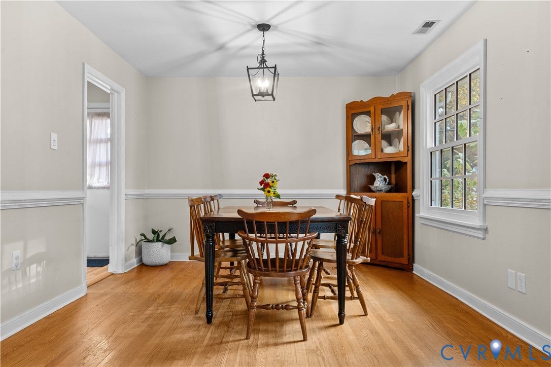 6956 Old Westham Road, Stratford Hills/Cherokee Road, Richmond, VA 23225 Dining area featuring wood-finish flooring, white chair rail molding, a built-in wooden corner hutch, and a hanging geometric lantern pendant light