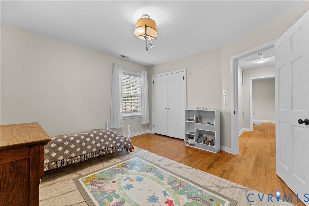 6956 Old Westham Road, Stratford Hills/Cherokee Road, Richmond, VA 23225 Neutral-toned interior featuring wood-finish flooring, a double-door closet, multi-pane window, and decorative overhead lighting