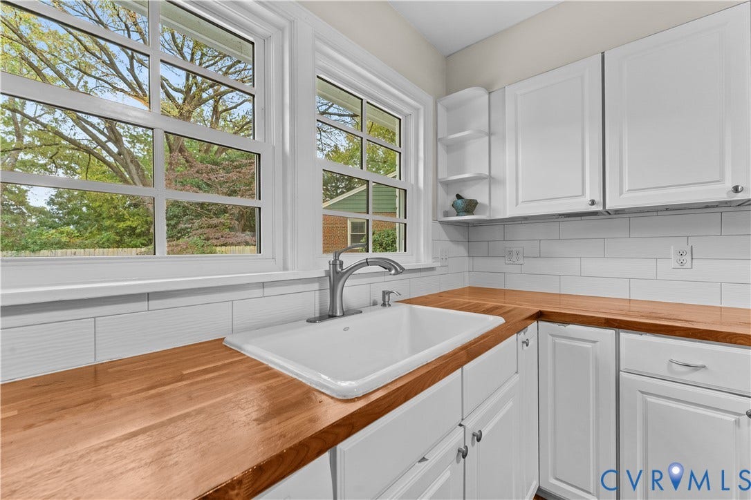 6956 Old Westham Road, Stratford Hills/Cherokee Road, Richmond, VA 23225 Kitchen featuring butcher block countertops, white shaker-style cabinetry, a white apron-front sink with a high-arch faucet, and white subway tile backsplash