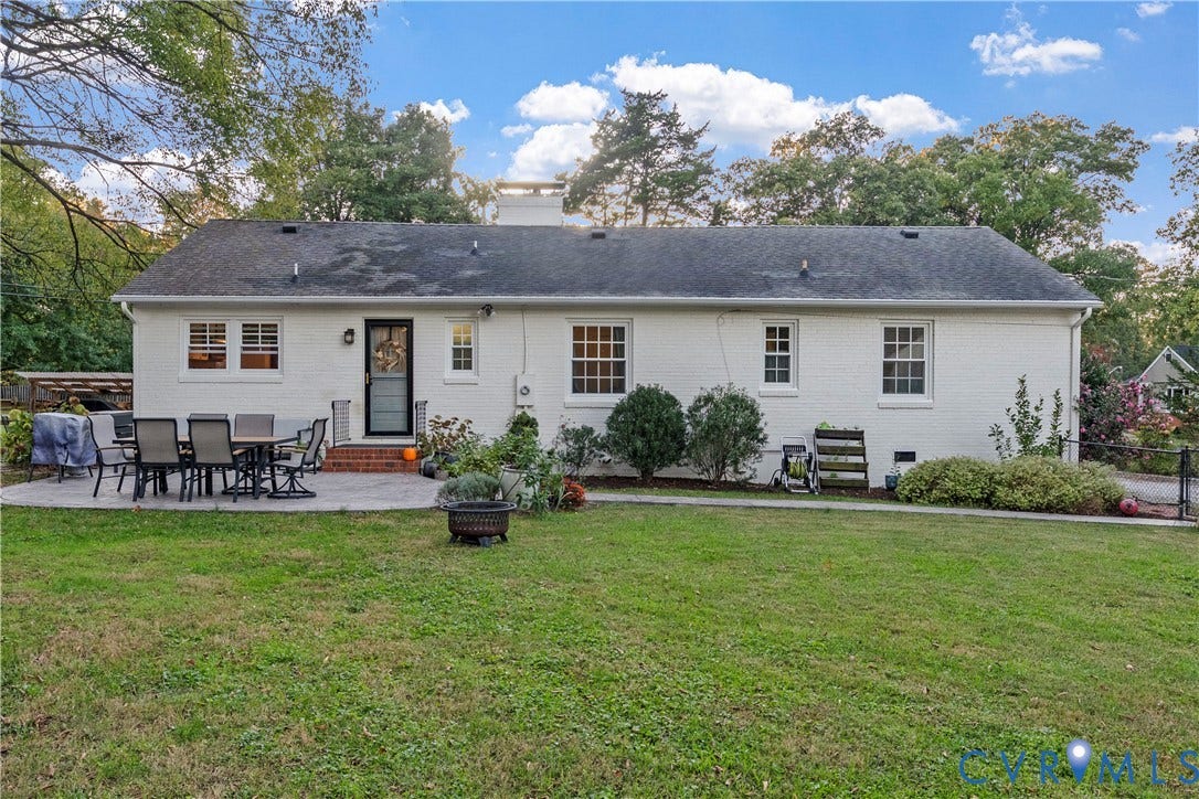6956 Old Westham Road, Stratford Hills/Cherokee Road, Richmond, VA 23225 Painted brick exterior featuring a multi-paned window configuration, rear brick stoop, and expansive lawn with mature perimeter trees