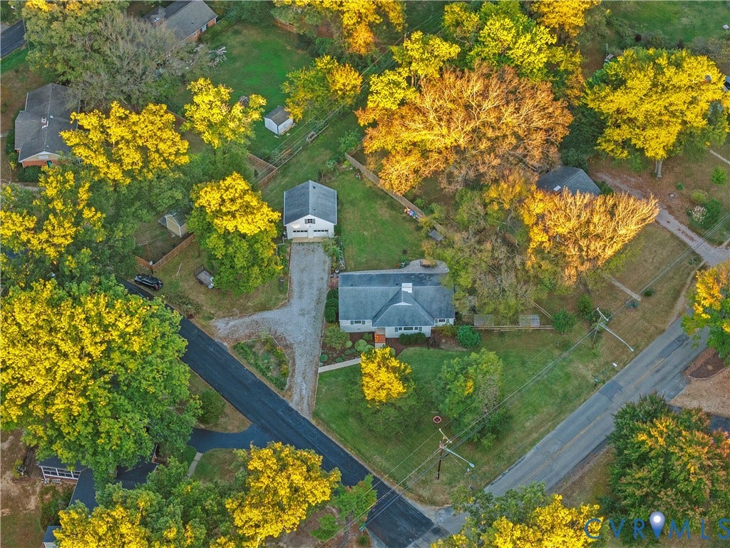 6956 Old Westham Road, Stratford Hills/Cherokee Road, Richmond, VA 23225 Aerial perspective of a detached residential property featuring a sprawling lot, a detached garage, a gravel driveway, and mature deciduous trees