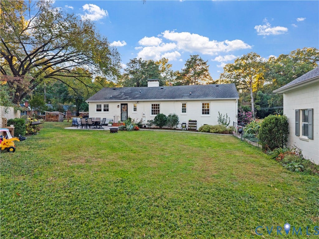 6956 Old Westham Road, Stratford Hills/Cherokee Road, Richmond, VA 23225 Spacious backyard featuring a manicured lawn, paved patio area, white brick exterior, and mature trees