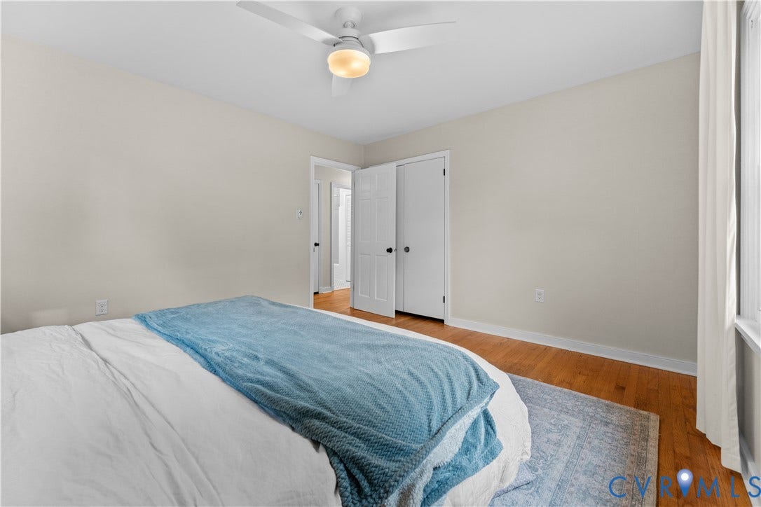 6956 Old Westham Road, Stratford Hills/Cherokee Road, Richmond, VA 23225 Bedroom featuring wood-finish flooring, a white ceiling fan with integrated lighting, and a double-door closet with six-panel doors