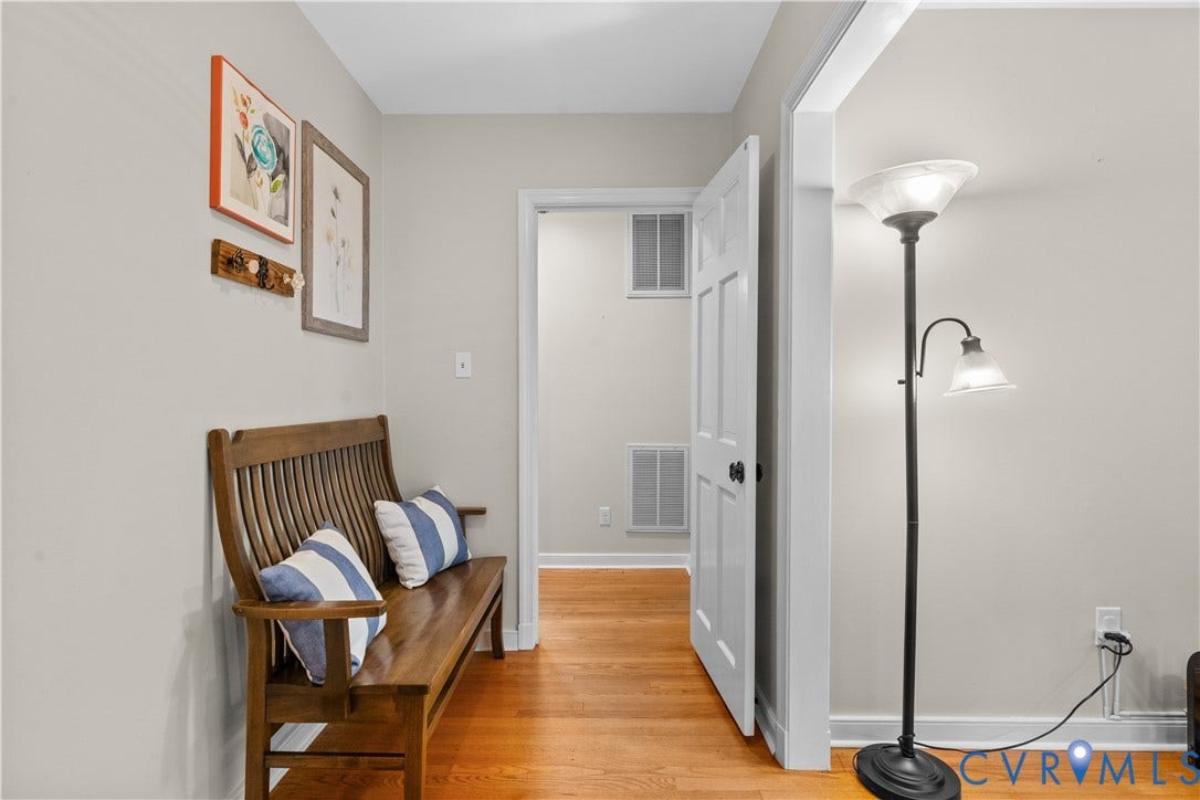 6956 Old Westham Road, Stratford Hills/Cherokee Road, Richmond, VA 23225 Interior space featuring polished wood-finish flooring, neutral wall paint, and a six-panel interior door