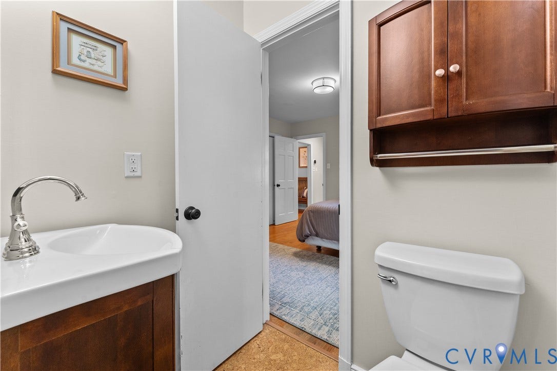 6956 Old Westham Road, Stratford Hills/Cherokee Road, Richmond, VA 23225 Wall-mounted wooden cabinet with a towel bar, ceramic pedestal sink, polished chrome faucet, and standard toilet
