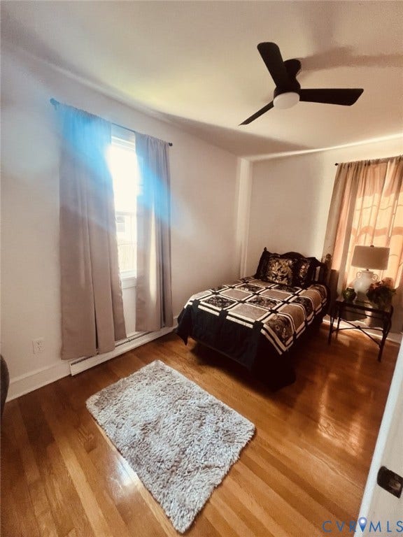 404 Ivey Avenue, Woodlawn, Colonial Heights, VA 23834 Wood-finish flooring, dual windows with natural light, and a modern three-blade ceiling fan