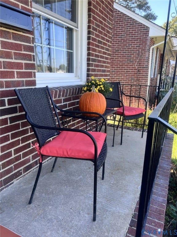 404 Ivey Avenue, Woodlawn, Colonial Heights, VA 23834 Red brick exterior featuring a concrete porch and black metal railings