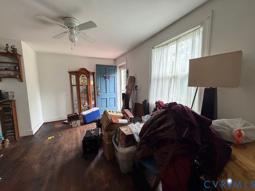 Hardwood flooring, multi-pane window, ceiling fan with integrated lighting, and blue-painted exterior door