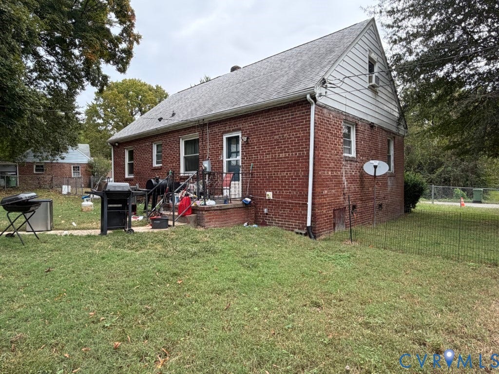 Exterior featuring red brick siding, a gabled roofline, and a masonry stoop