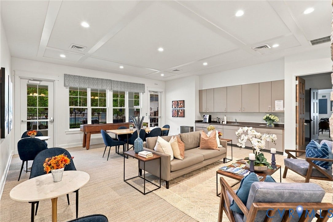 Common area featuring a coffered ceiling, recessed lighting, wall-to-wall cabinetry, and a kitchenette with a sink
