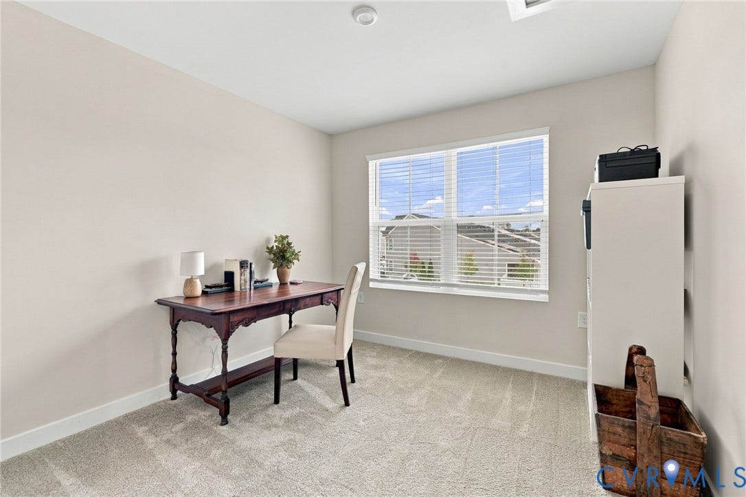 Neutral-toned wall paint, neutral carpeting, recessed ceiling lighting, and a multi-pane window with horizontal blinds