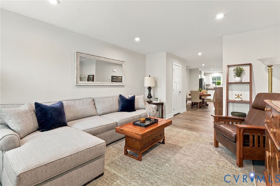 Living area featuring wood-finish flooring, recessed lighting, and a neutral color palette