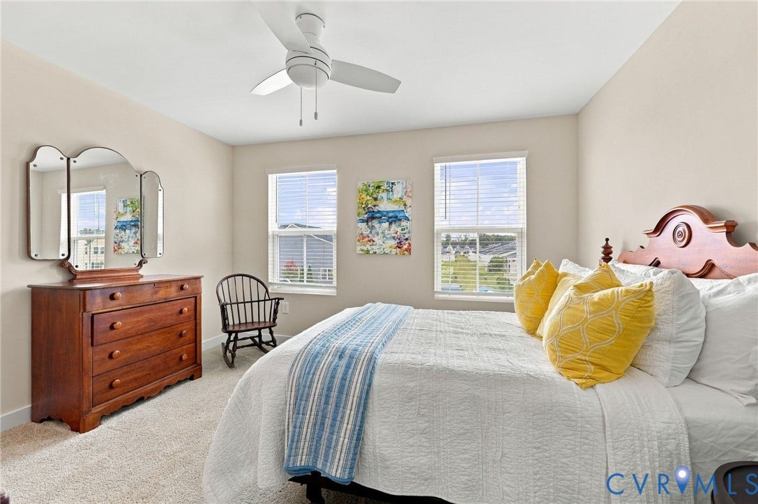 Neutral wall color, dual windows, ceiling fan, and wall-to-wall carpeting