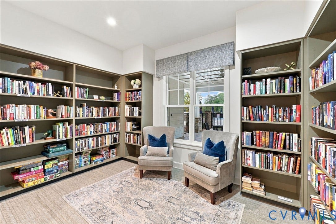 Floor-to-ceiling built-in shelving, custom cabinetry with integrated storage, dual-pane window with mullions, and recessed lighting