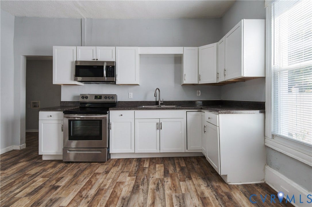 113 Spring Street, Pembroke, Petersburg, VA 23803 Kitchen featuring white shaker-style cabinetry, dark stone-finish countertops, stainless steel appliances, wood-finish flooring, and a single-basin sink with a gooseneck faucet