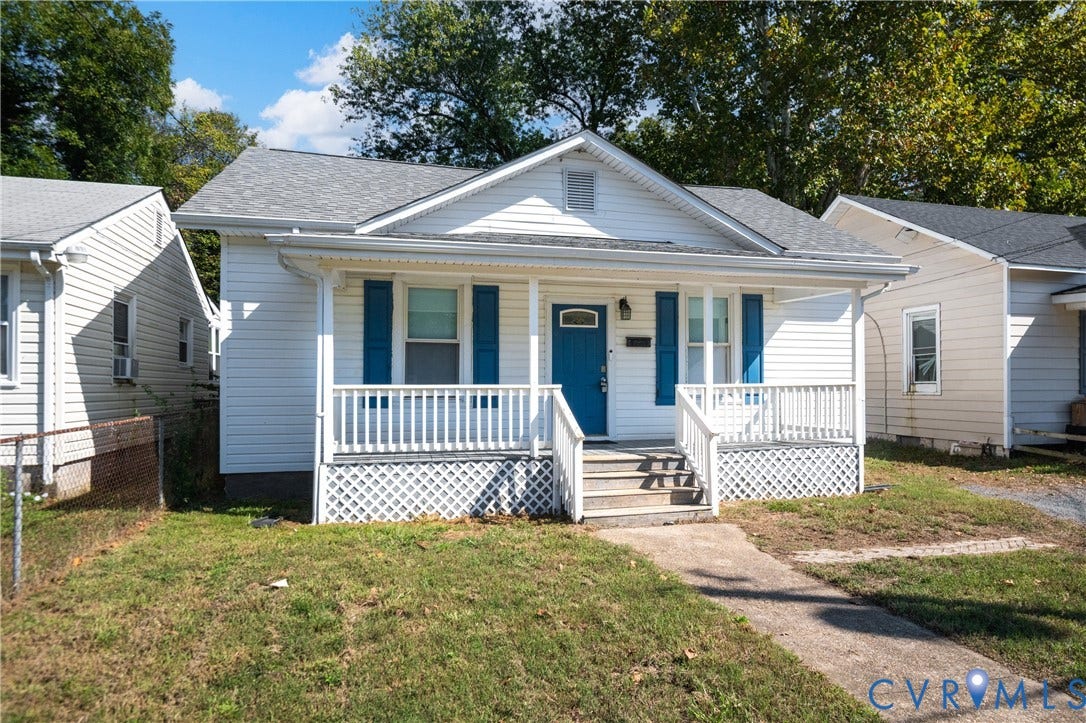 113 Spring Street, Pembroke, Petersburg, VA 23803 Single-story residence featuring white horizontal siding, blue shutters, a covered front porch with white railing, and decorative lattice skirting