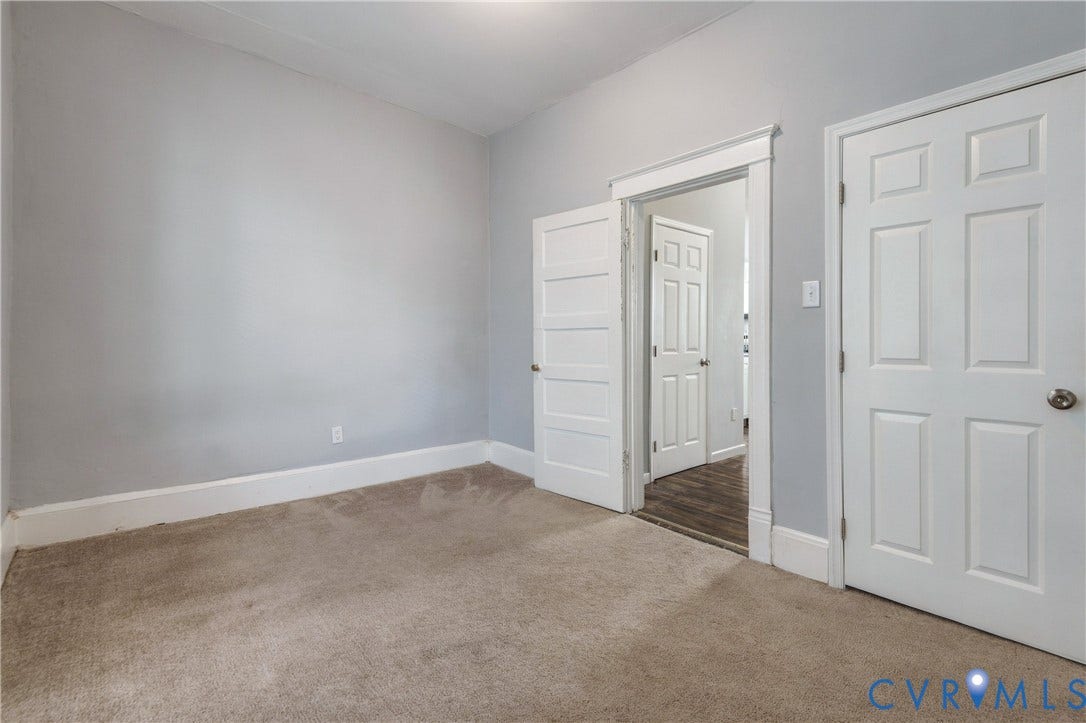 113 Spring Street, Pembroke, Petersburg, VA 23803 Interior space featuring neutral-toned carpeting, crisp white interior door trim, and paneled doors