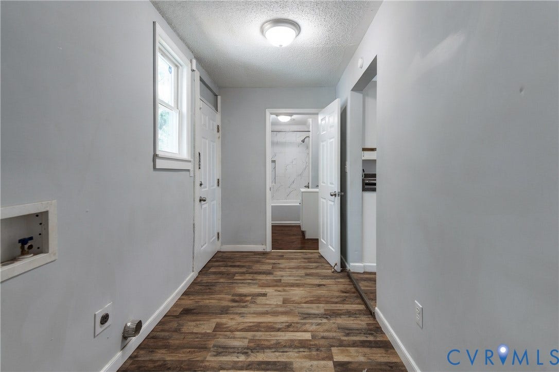 113 Spring Street, Pembroke, Petersburg, VA 23803 Utility space featuring wood-finish flooring, a recessed laundry hookup station, a paneled door, and flush-mount ceiling lighting